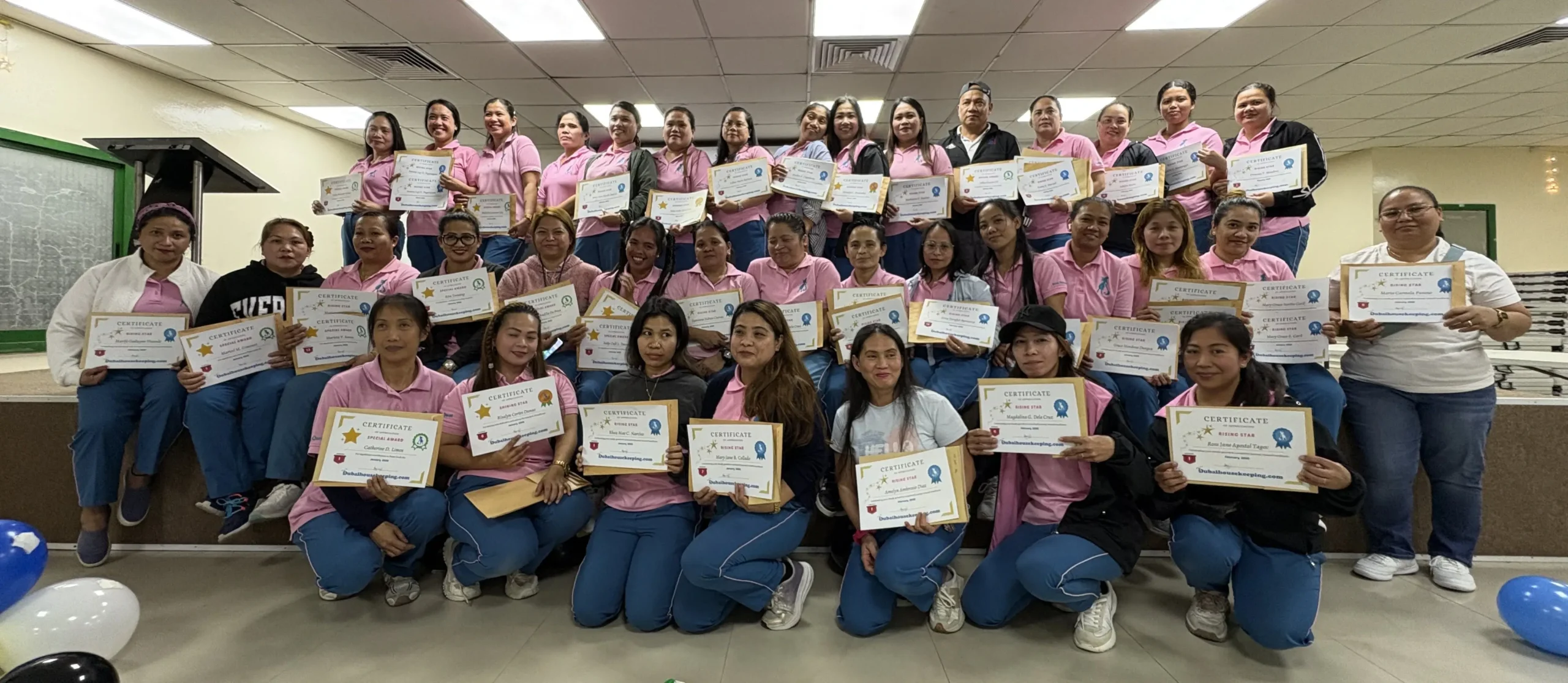 Dubai Housekeeping team members holding achievement certificates during a staff recognition and incentive event in Dubai